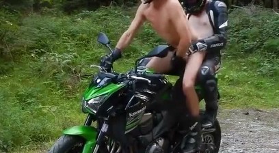 Two Muscular Guys On A Green Motorcycle