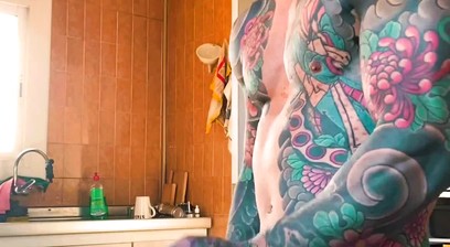 Stunning tattooed man jerks off his massive cock