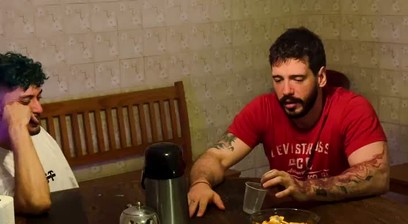 The wife returned early and saw her husband being suckled by his best friend.