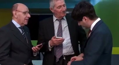 A young person teaches two old men