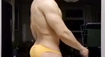 Guy Flexing and Posing In Yellow Posing Trunks