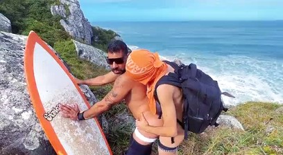 A cheeky surfer getting a dick and piss from a tourist.