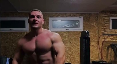 Bodybuilder works out in pink thong