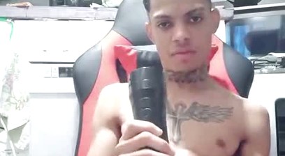 young man using a masturbator on live stream.