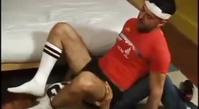 Two Young Men-One Sniffing The Other's Socks