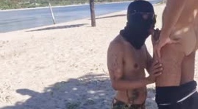 masked man having sex on the beach