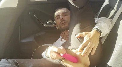 Kinky gentleman slave spread legs and plays with his ass in a car in public