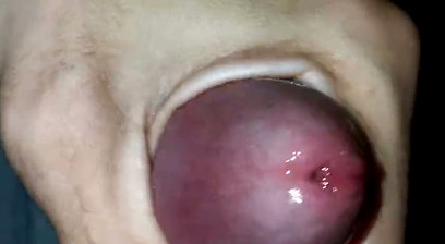 Playing with the head of a wet penis